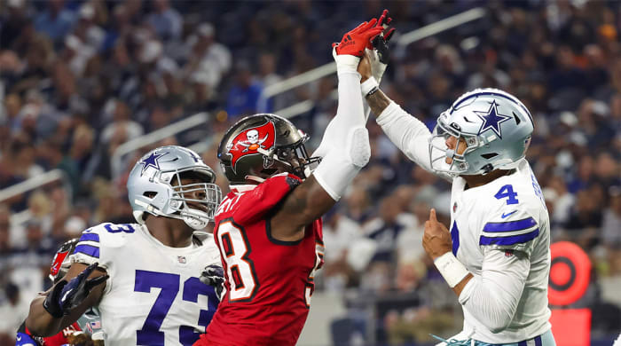 Sep 11, 2022; Arlington, Texas, USA; Dallas Cowboys quarterback Dak Prescott (4) hits his hand against Tampa Bay Buccaneers linebacker Shaquil Barrett (58) while throwing during the fourth quarter at AT&T Stadium.